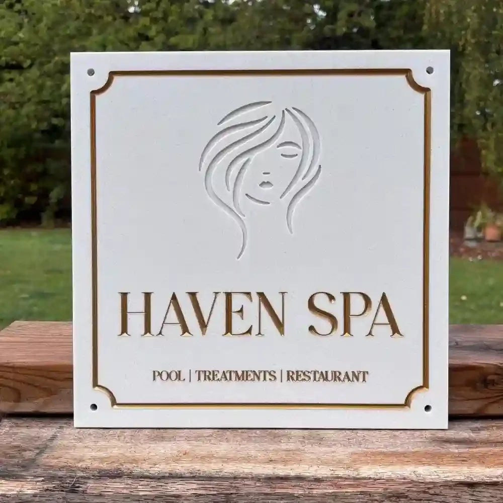 Haven Spa sign with logo on a wooden surface