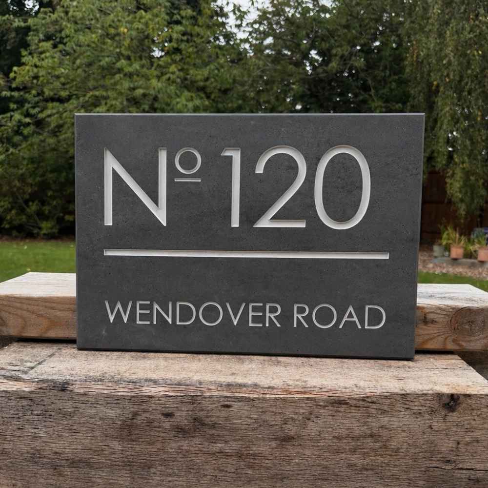 House number sign 'No 120 Wendover Road' on a stone background
