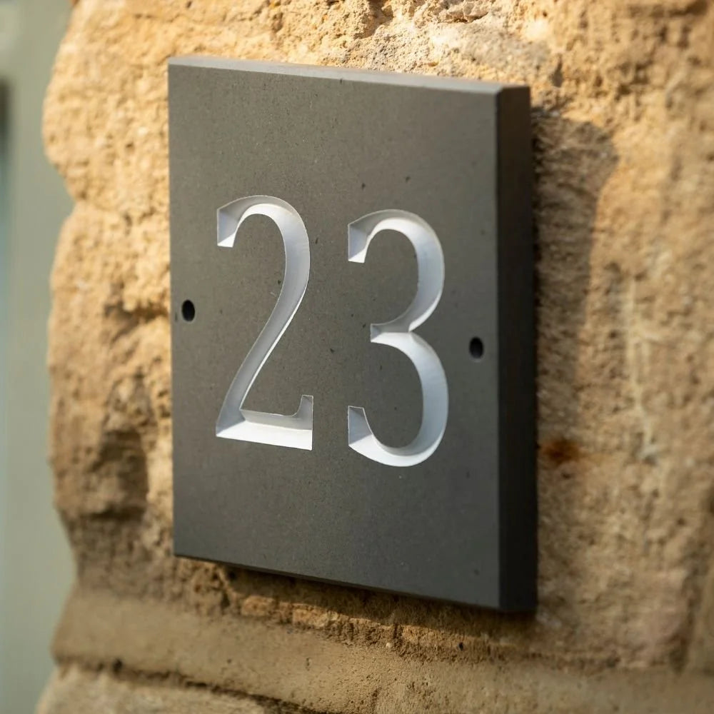 House number '23' on a stone wall