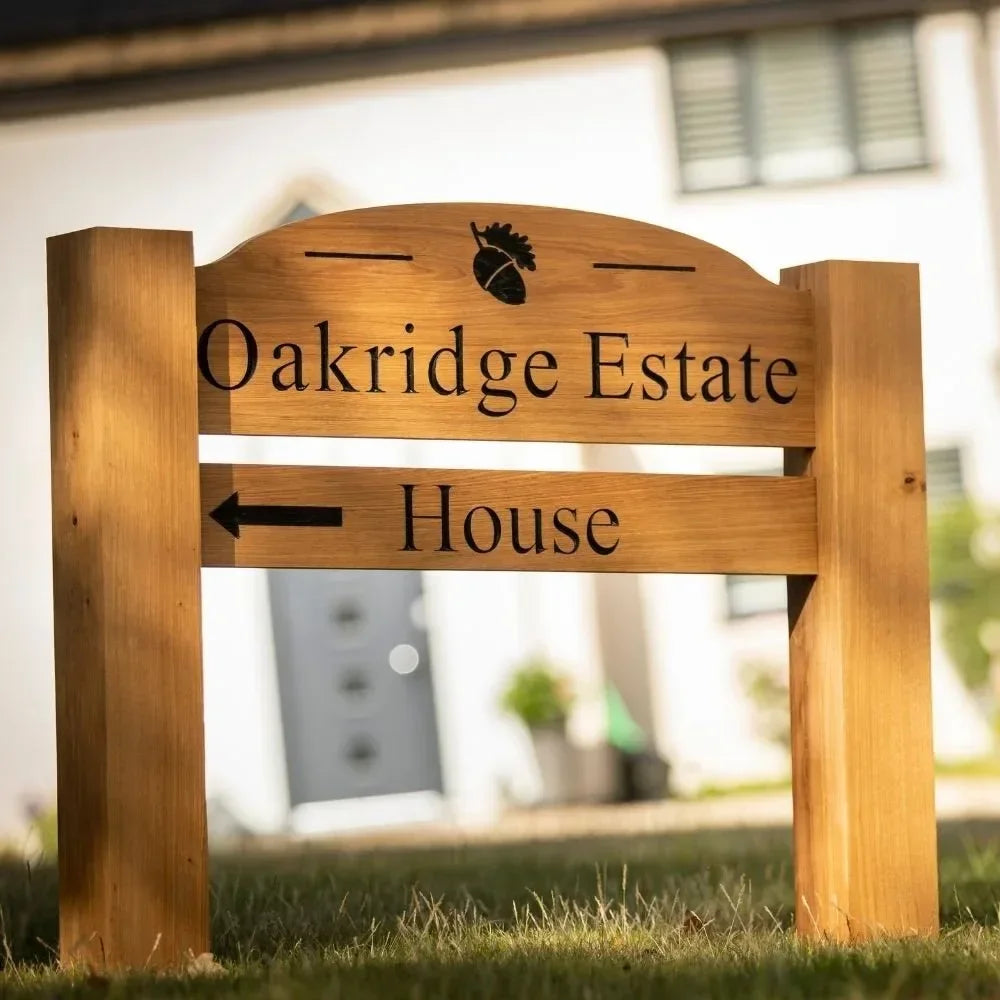 Wooden sign with 'Oakridge Estate House' text on a blurred background