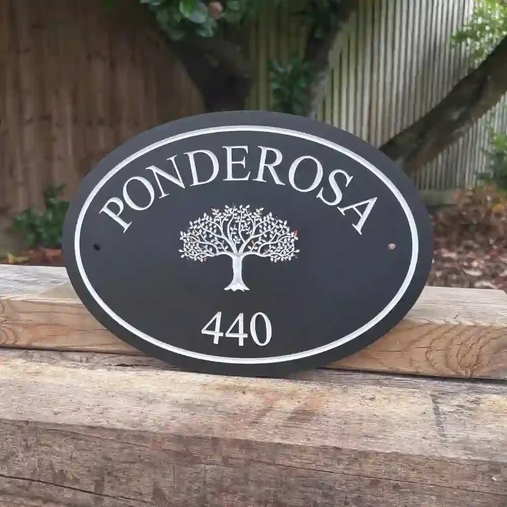 Oval House sign with 'Ponderosa' and number '440' on a wooden surface