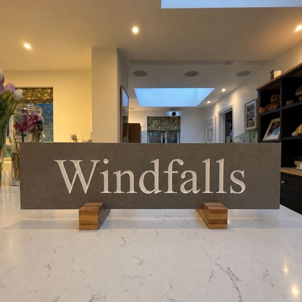 A horizontal mink sign with the word 'Windfalls' in white serif letters.