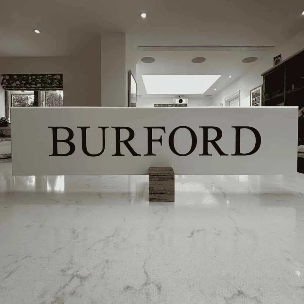 White reception desk with 'BURFORD' sign in a modern interior setting