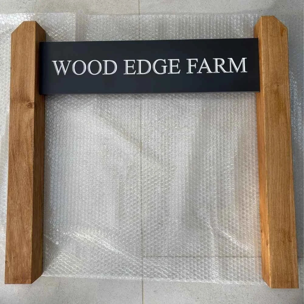 Wooden sign with 'WOOD EDGE FARM' text on a bubble wrap background
