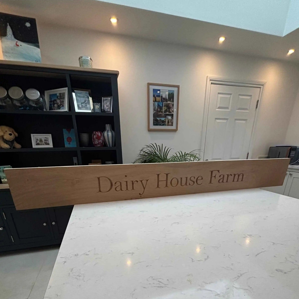 Reception area with a wooden sign reading 'Dairy House Farm' in a well-lit room.