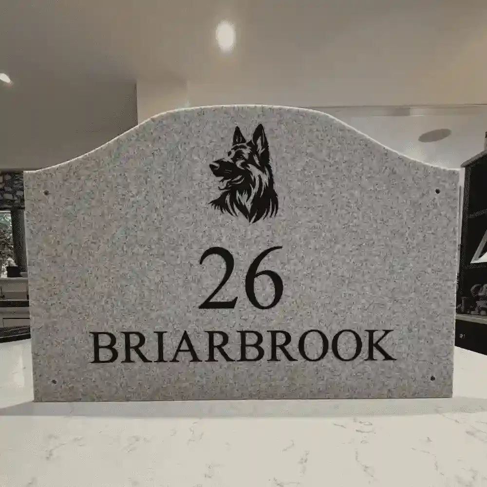 Granite headstone with dog engraving and text '26 Briarbrook'