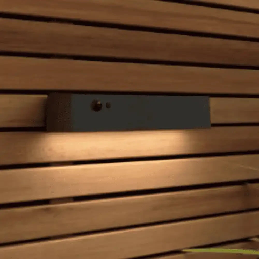 Black rectangular object on a wooden surface